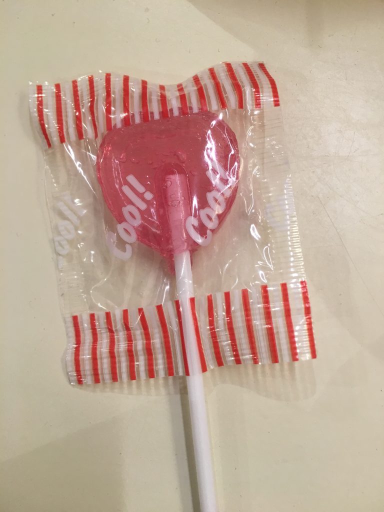 A red heart-shaped lollipop with the words "cool!", "cool!" on it.