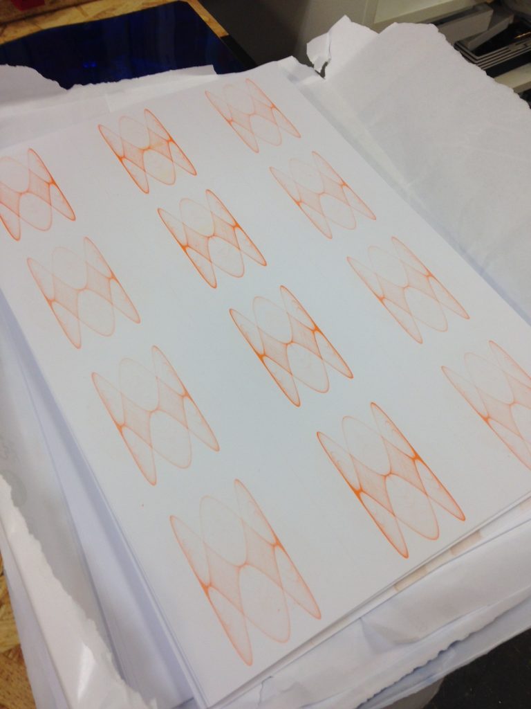 An orange repeated pattern printed on white card
