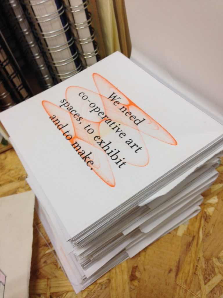 A stack of white cards printed with orange image and black text