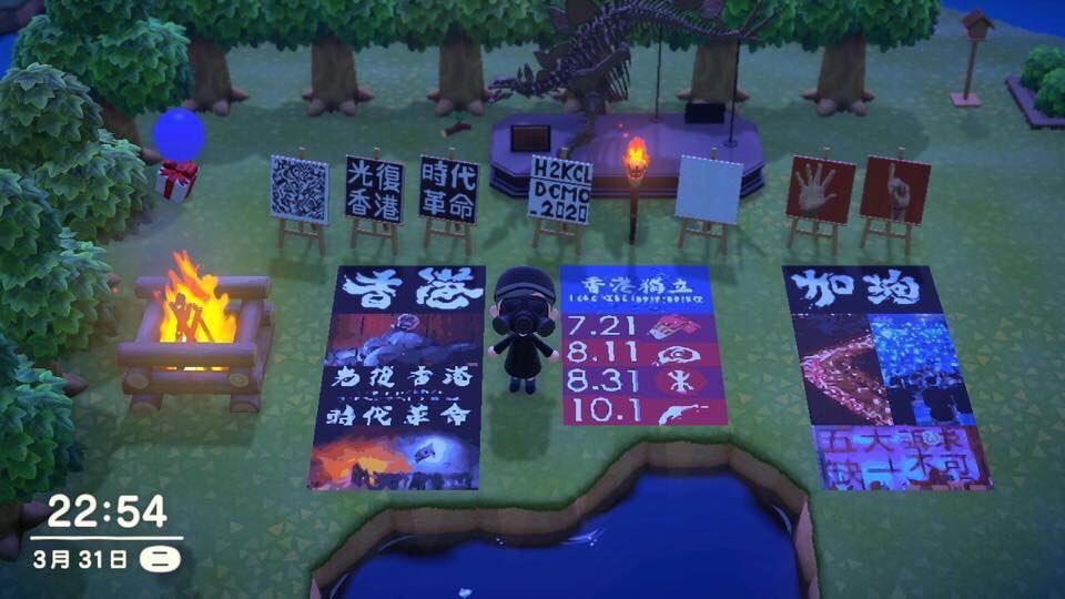 A scene in Animal Crossing. A black-clad protester with black gas mask stands in the middle of a park with trees in the background and on the left. There is also a bonfire on left. Behind the protester, there are 6 paintings on easels, 2 paintings are with slogans in Chinese character, 1 painting is with an open palm and 1 painting with a finger pointing up. These 2 hand gestures represent the slogan 'Five demands, not one less (fewer)'. On the grass, there are 3 banners with different slogans, images of the protests and key dates in the movement, such as July 21 and August 31, when protesters and passengers in the tube were brutally and indiscriminately attacked by gang of thugs and police. 