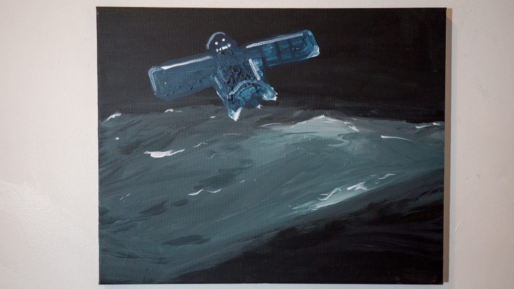 Acrylic on canvas painting. Black background with dark blue green in the middle looks like sea and a human like artificial satellite in dark blue on the left top.