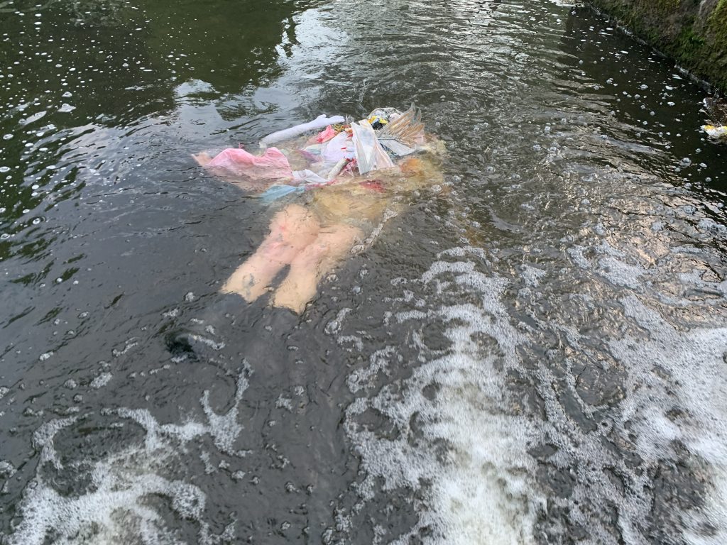 a body in the water under foam 