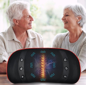 Two older people sat at a table facing each other visible from the waist up, they are smiling and looking happy. In the foreground on the table is a round disc like piece of equipment. It's black with a golden spine glowing centrally and wavy blue lines around it as well as 3 buttons either side on both sides. 