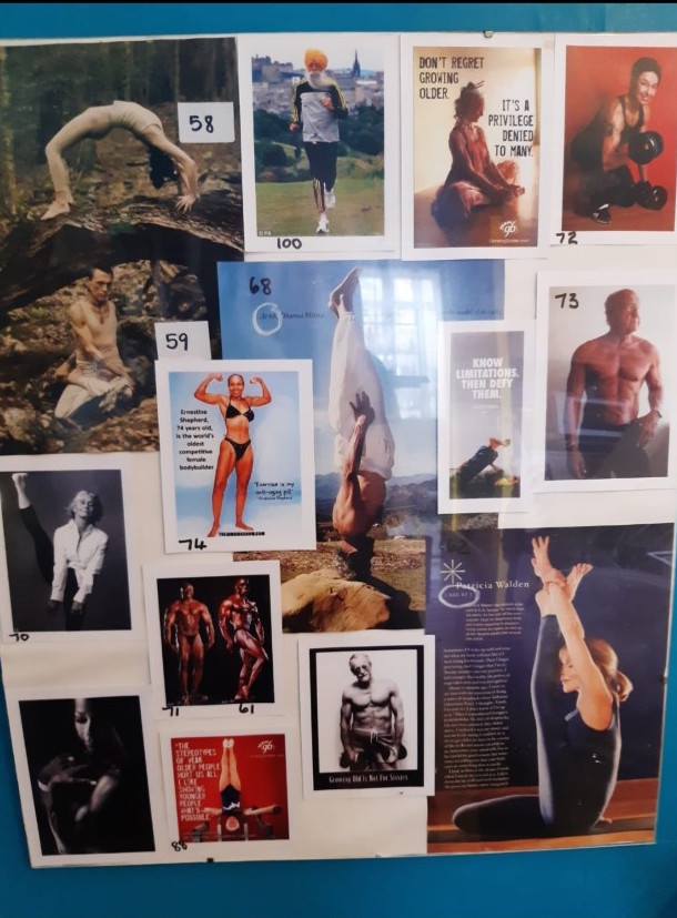 A mood board of many rectangular images that have either been cut from magazines or printed at home on a computer, arranged and put inside a clip frame. They include muscly older people doing a variety of fitness activities including yoga, body building, swimming and running. Many of them are posed with little clothing on to present their physique. The images have been marked with numbers in a black felt pen, these are the ages of the people shown in the pictures which range from 58 to 100 years old. Some of the images contain text, inspirational quotes from the people in the pictures and information about them, which is mostly not big or clear enough to read. Some quotes that are visible say, 'Don't regret growing older. It's a privilege denied to many' and 'Know Limitations. Then Defy Them.' 