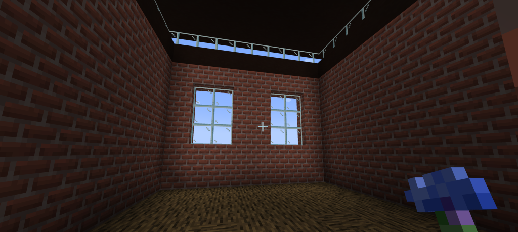 Screenshot of inside Foredown Tower on Minecraft with brick walls, wooden floor and light coming in from the windows.