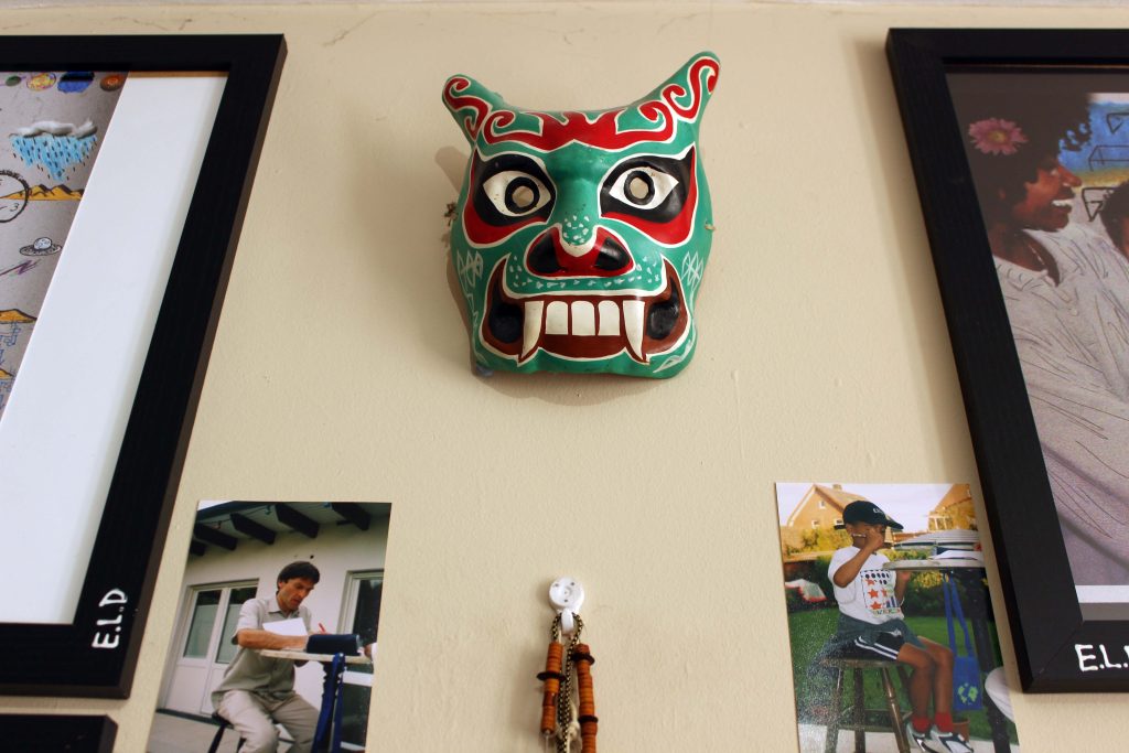 Decretive mask from childhood hung on wall.  