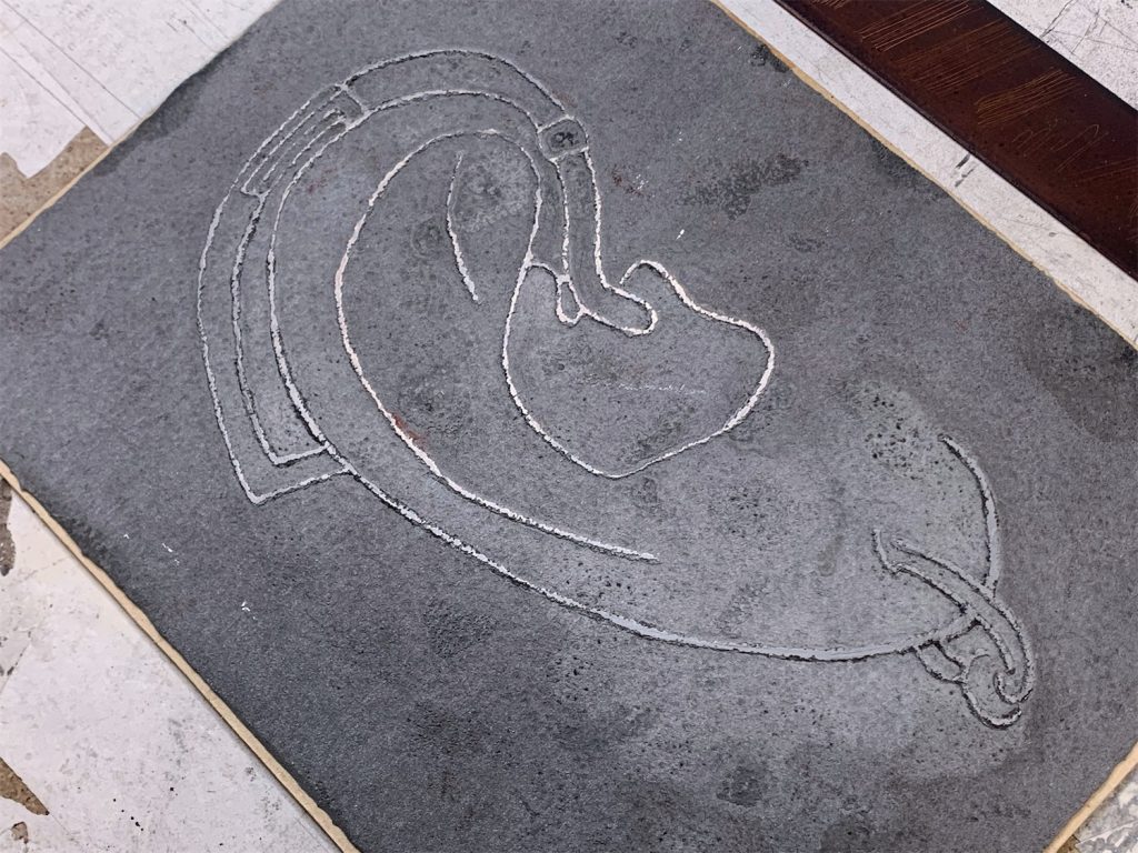 Etching in gray on metal plate