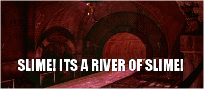 An animated gif from the movie Ghostbusters 2. It is a long-shot showing Dan Ackroyd's character with a hardhat and headtorch, and holding a torch in his hands, dangling from a wire into a cavernous sewer space, with his legs frantically kicking. The whole image is in a reddy-pink hue. A central river of bright pink liquid is quickly flowing beneath Dan's character into a circular tunnel. At the bottom of the image is a subtitle in bold font and capitalised that reads: "SLIME! ITS A RIVER OF SLIME!"