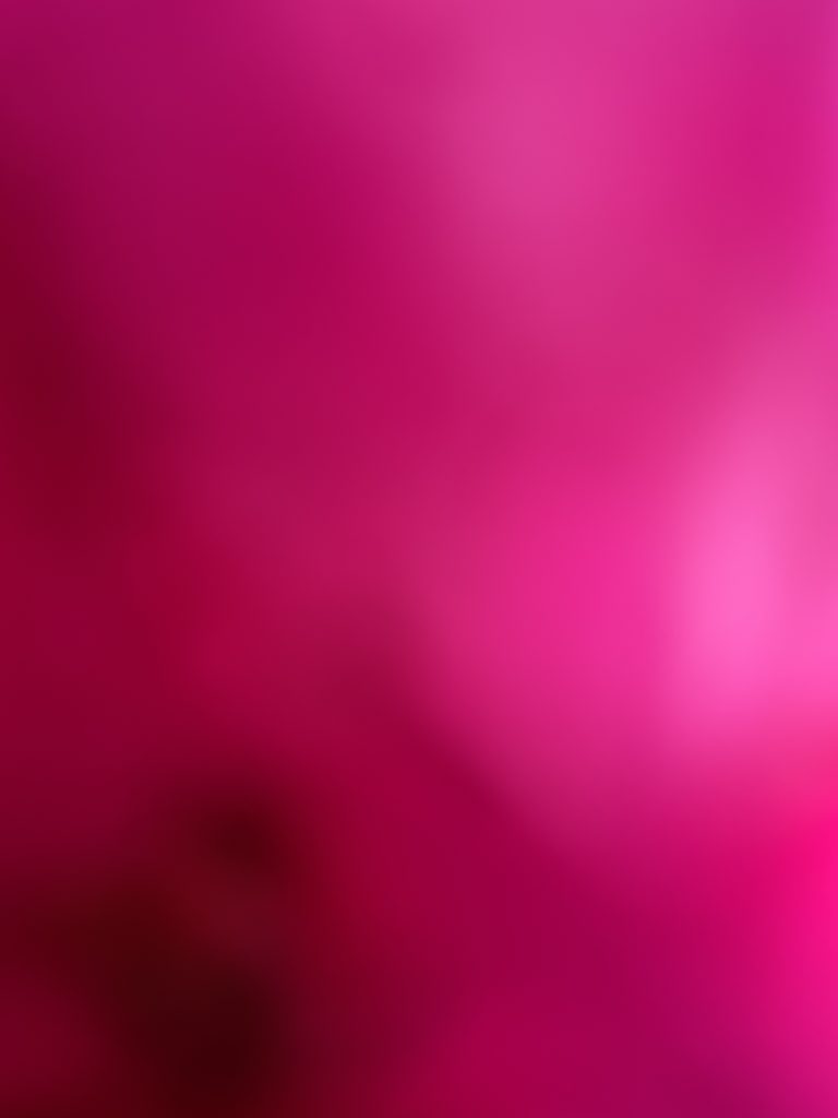 A digital photograph (portrait, colour), of what looks like an abstract image in shades of bright pink, fuschia, deep reds and burgundy. It looks like some kind of far off star nebulas, and it also looks like a an image caught on an iphone of the inside of someone's pocket; deep colours in a soft crumpled blurring centres, bright light spots across the image. 