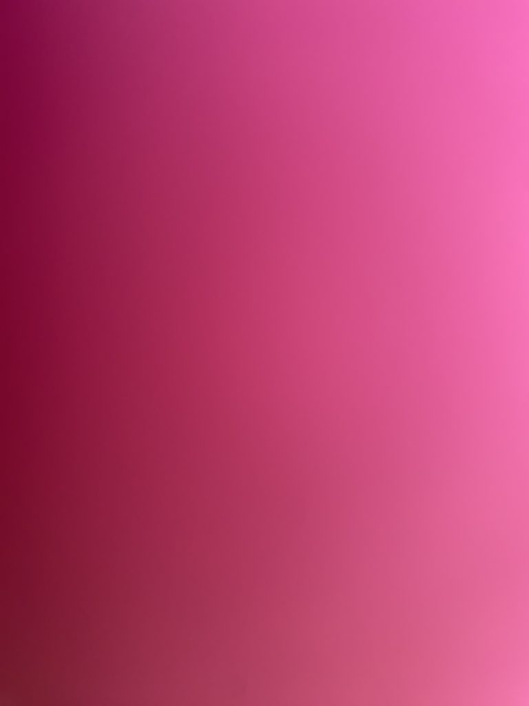 A digital photograph (portrait, colour), of what looks like some abstract image in shades of pink. It looks like a colour swatch of some posh paint, spanning in a gradient from deep pink running down the left of the image, fading to alight,  dusky, baby pink to the right of the image. It is not at all clear what the image is depicting; shape and colour are its only feature.