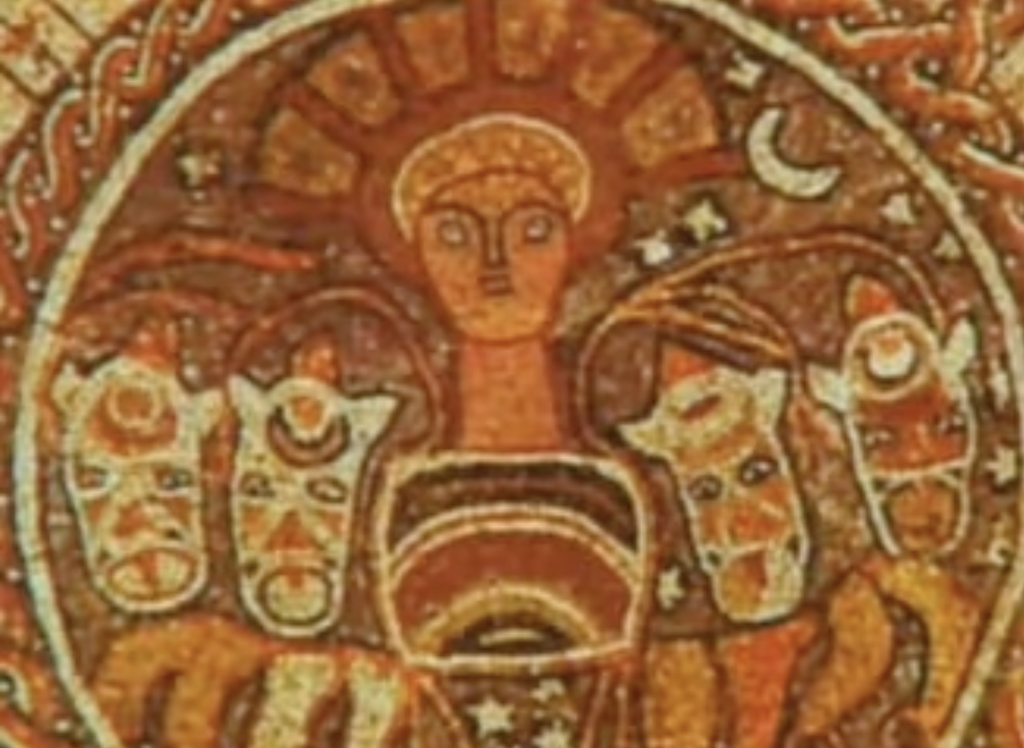 A low-res photo of an artwork, probably a mosaic. In orange, red and brown earth tones, a person in a headdress is at the centre, two cows, or maybe bulls, are to each side of her.